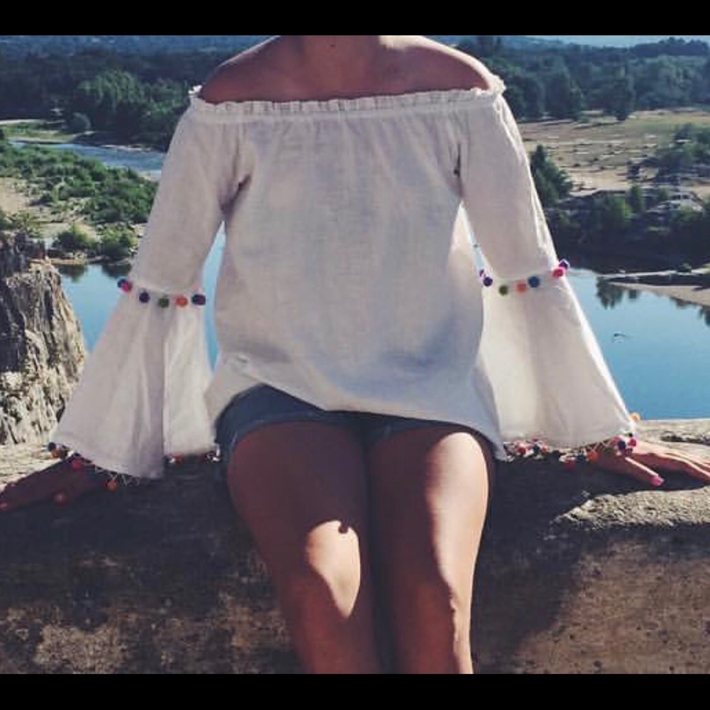 off the shoulder top with multicolored Pom Poms